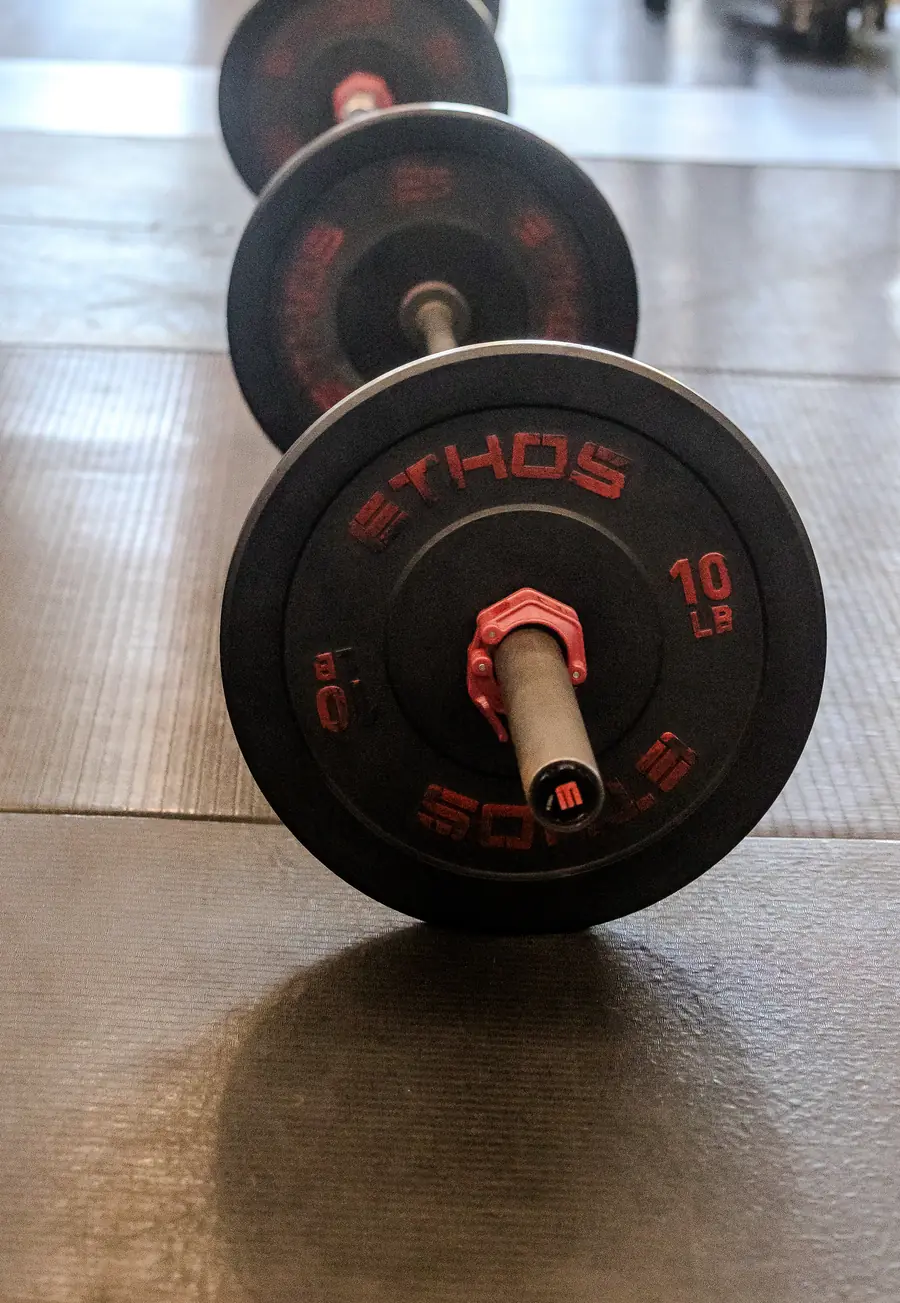 a loaded barbell resting on the gym floor