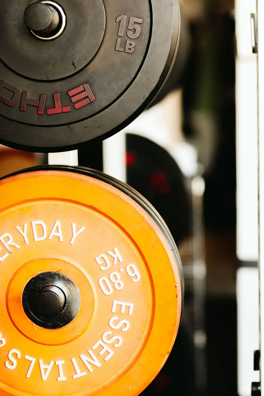 stacked bumper plates on the rack